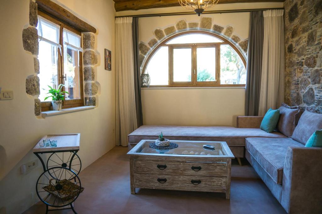 a living room with a couch and a table at To Spiti mas in Sougia