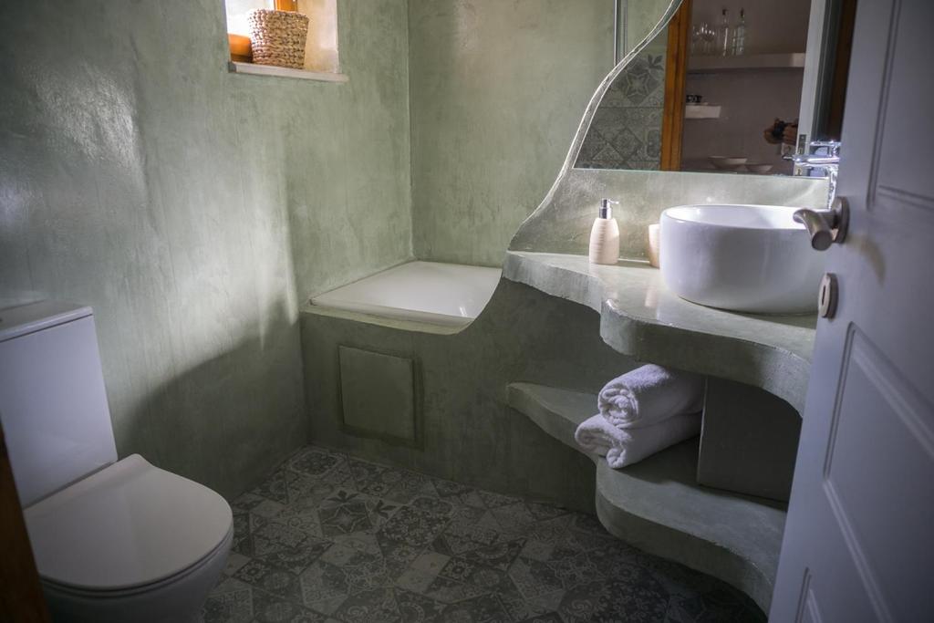 a bathroom with a sink and a toilet at To Spiti mas in Sougia