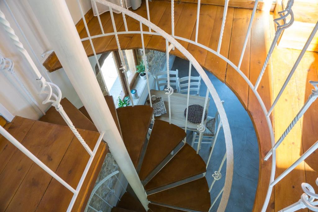 a spiral staircase in a house with wooden floors at To Spiti mas in Sougia