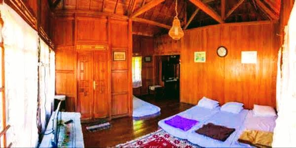 Säng eller sängar i ett rum på Oemah Kajoe Lembang