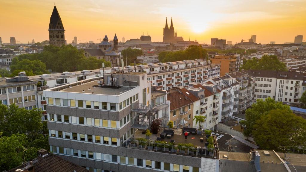 an aerial view of a city at sunset at Hostel Köln in Cologne
