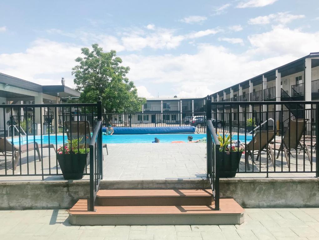 a swimming pool at a hotel with a playground at Oasis Inn in Kelowna