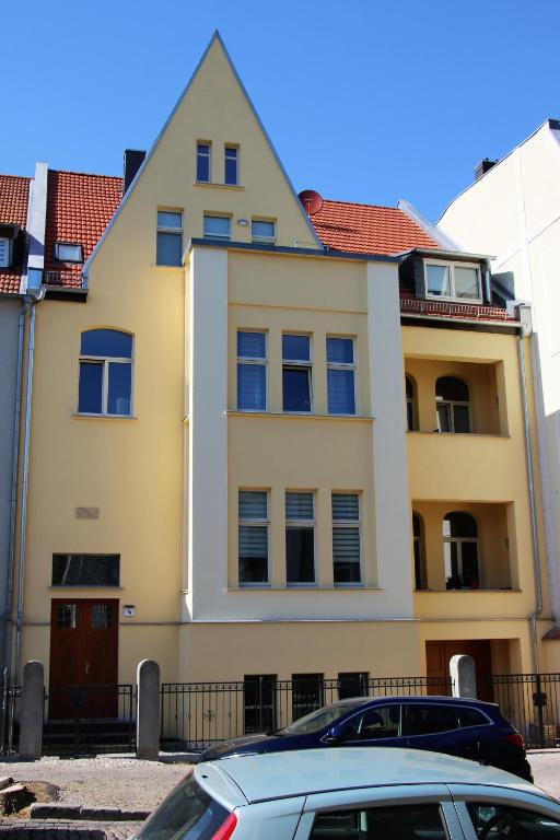 a building with a car parked in front of it at Pension Bernburg A² in Bernburg