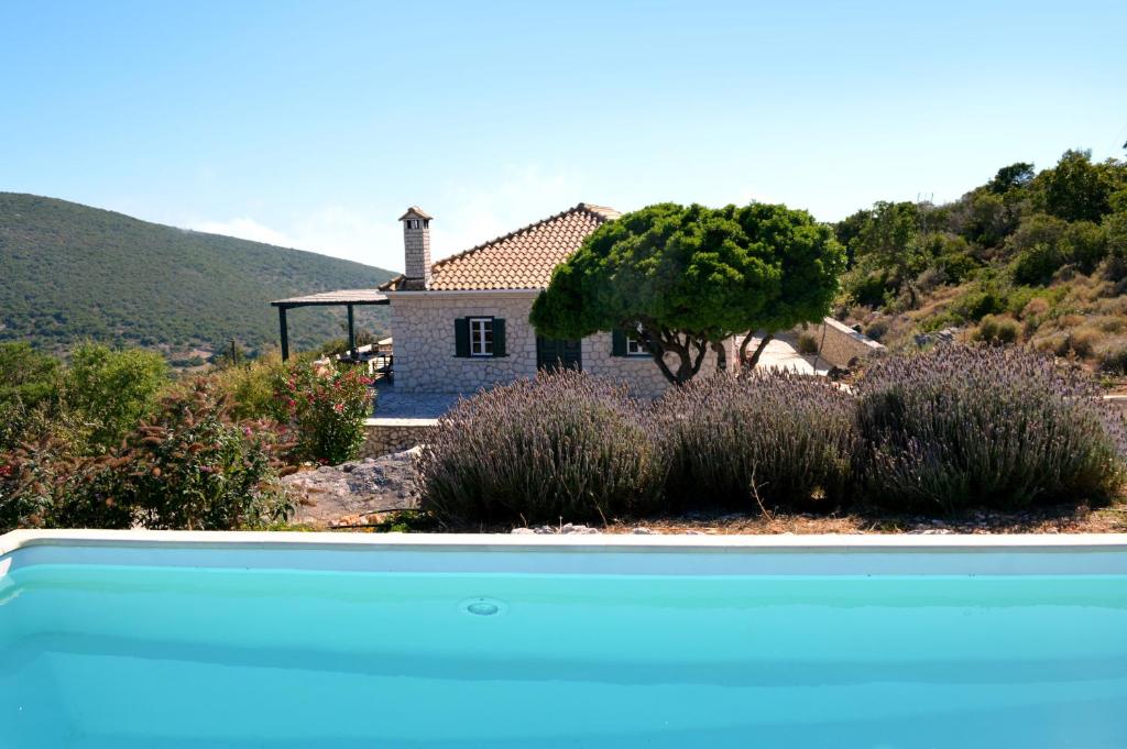 a house with a pool in front of a house at Urania Luxury Villa Geofos in Póndi