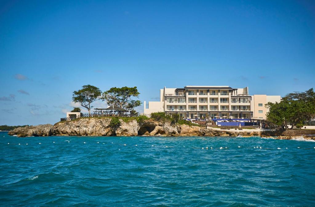 a large building on a rocky island in the water at Grand Lido Negril Au-Naturel, An Autograph Collection All-Inclusive Resort - Adults Only in Negril