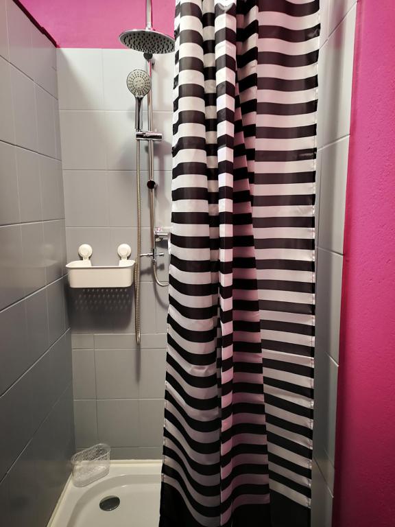 a bathroom with a black and white shower curtain at DanHostel in Warsaw