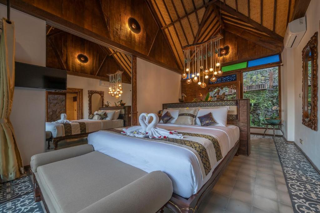 Postel nebo postele na pokoji v ubytování Menzel Ubud