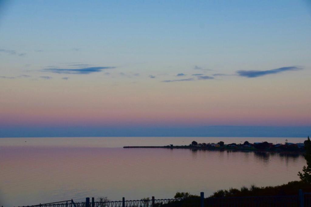 a view of a body of water at sunset at Stansbury Holiday Motel in Stansbury