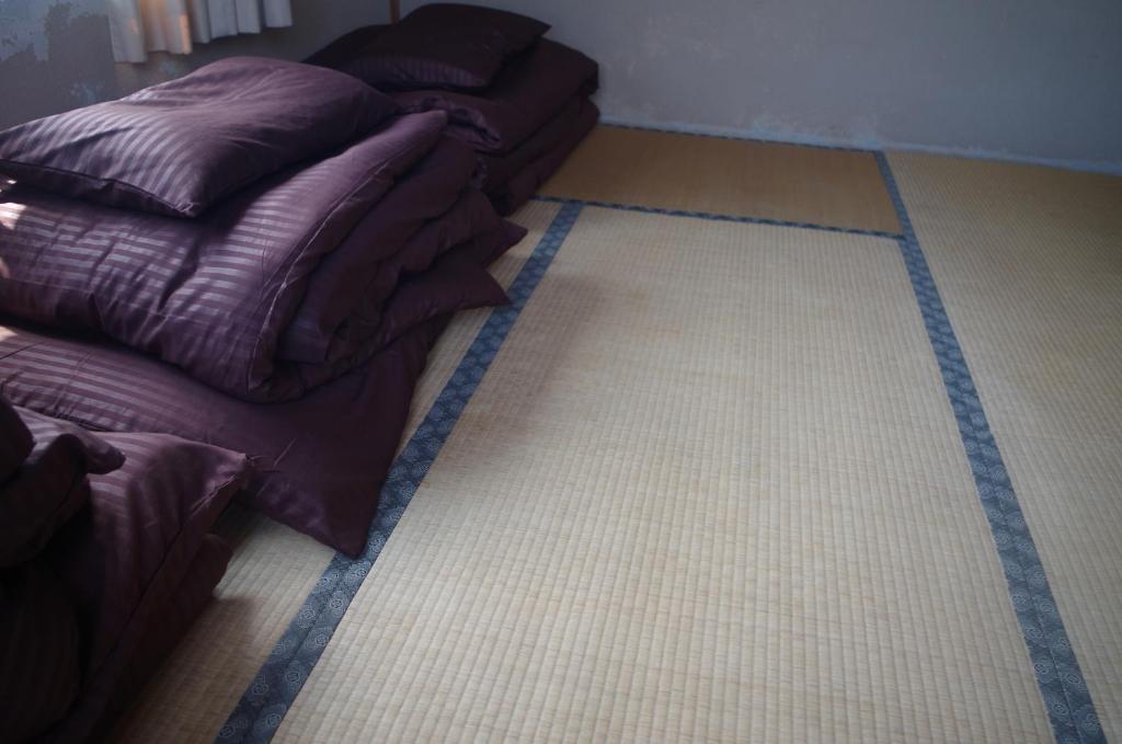 two pillows sitting on the floor in a room at Kusatsu Onsen Guesthouse Gyoten in Kusatsu