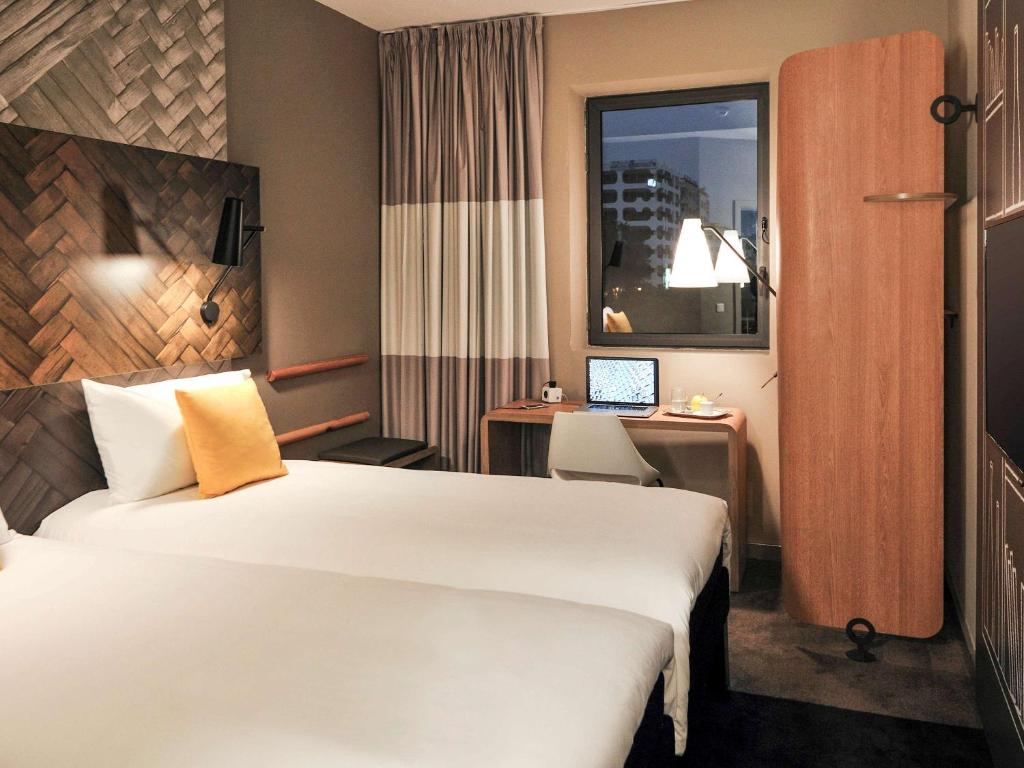 Postel nebo postele na pokoji v ubytování Ibis Casa Voyageurs