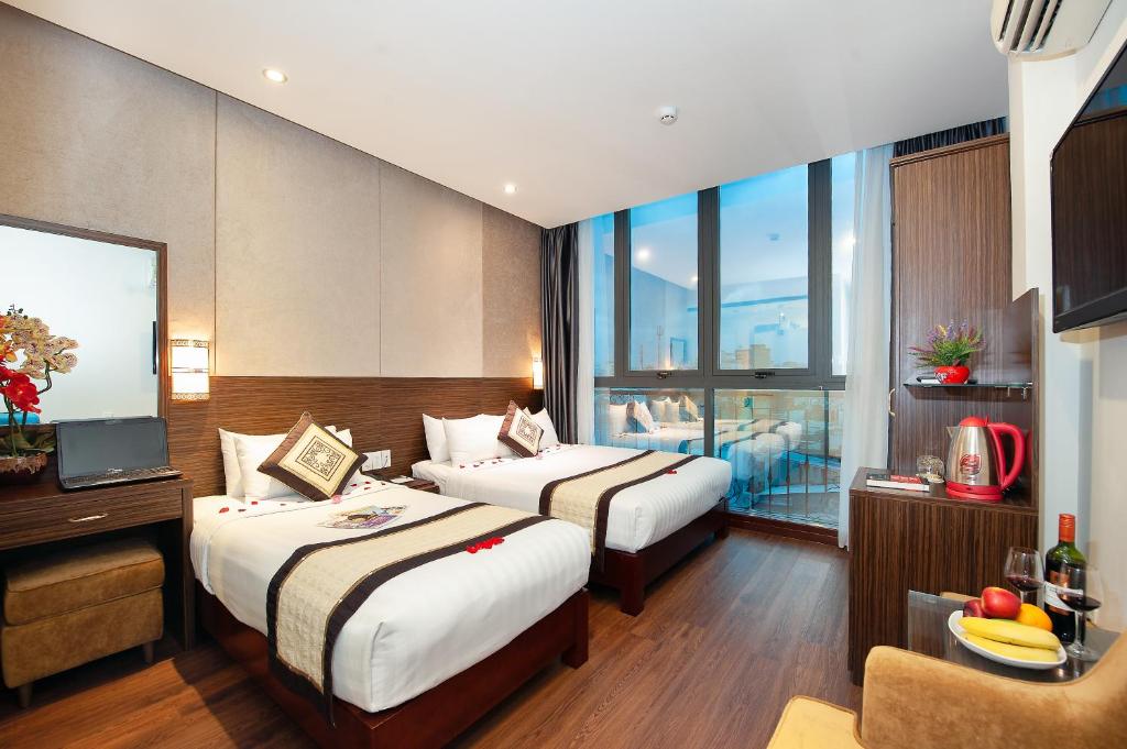 Ένα ή περισσότερα κρεβάτια σε δωμάτιο στο Saigonciti Hotel