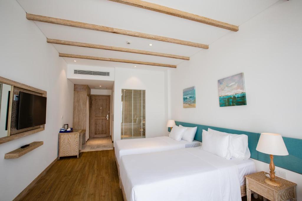 Giường trong phòng chung tại Risemount Premier Resort Da Nang