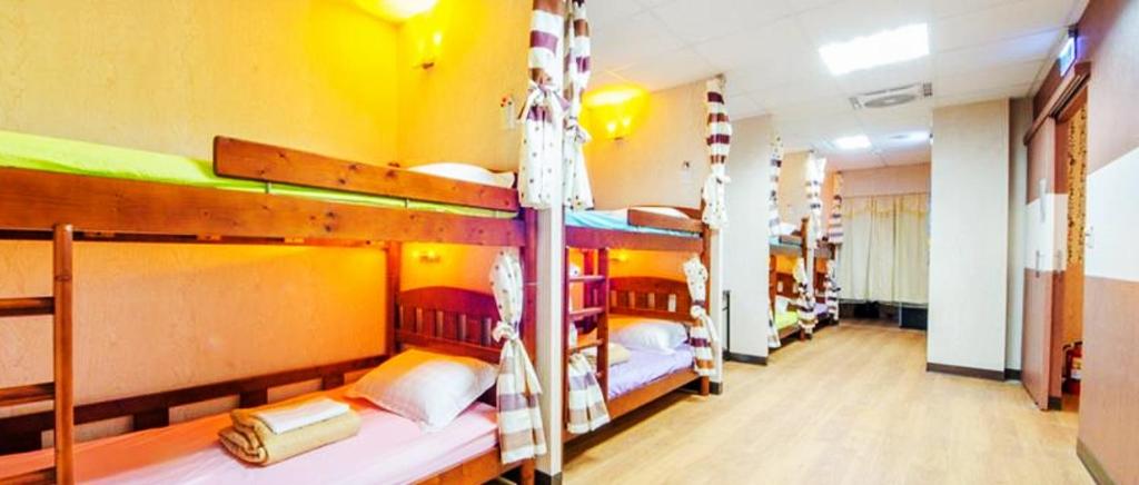 a group of bunk beds in a room at Non-profit bee home in Keelung