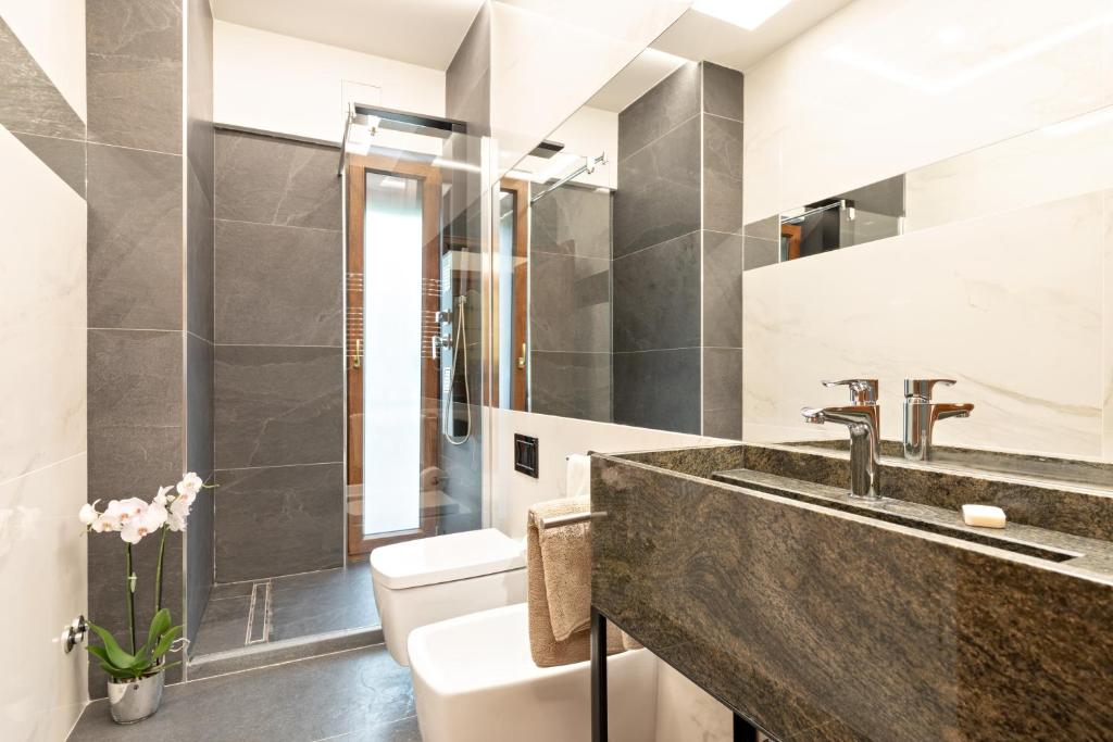 a bathroom with a sink and a toilet at First Class Rome Apartments in Rome