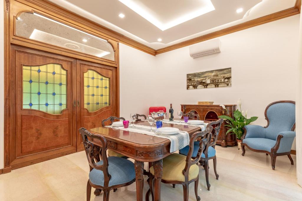 a dining room with a wooden table and chairs at First Class Rome Apartments in Rome