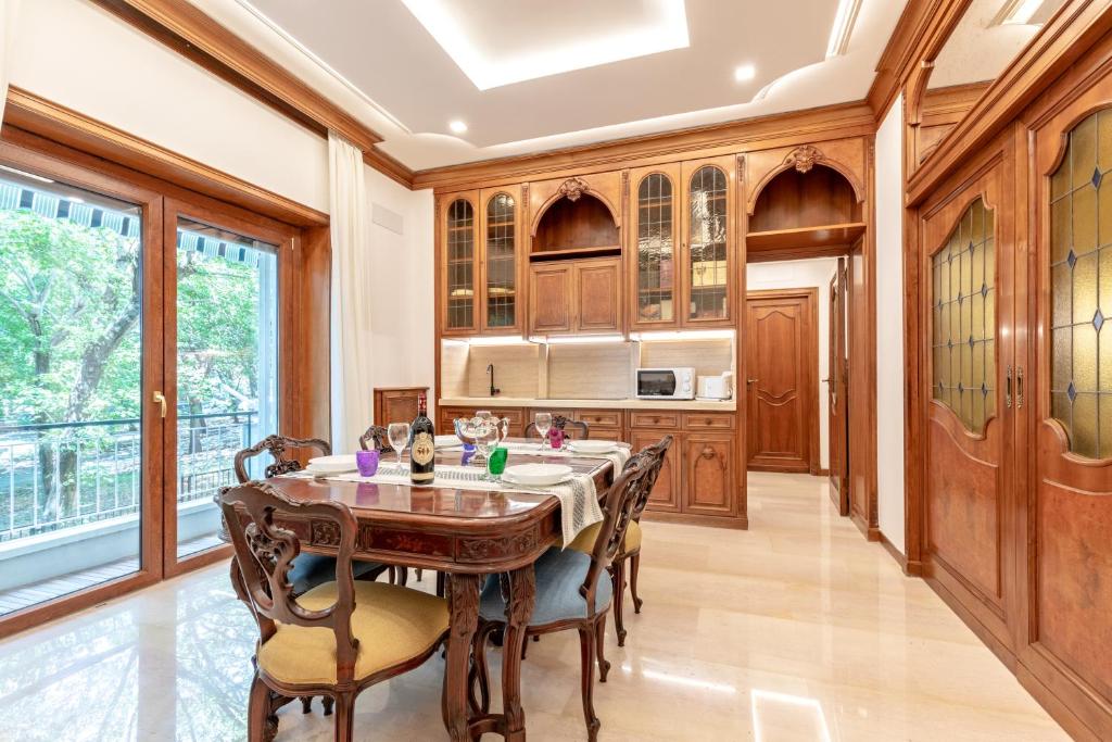 a kitchen with a wooden table and chairs at First Class Rome Apartments in Rome
