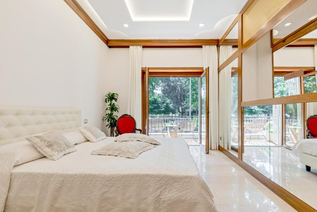 a bedroom with a large bed with two red chairs at First Class Rome Apartments in Rome