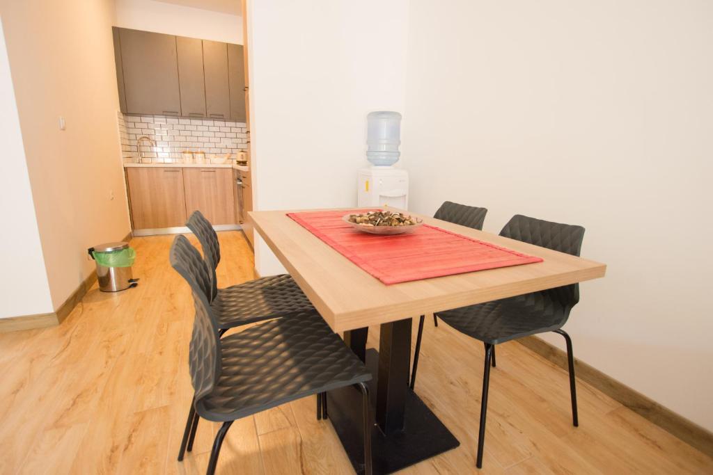 a dining room with a table and chairs at Trsteno Beach Apartments in Budva