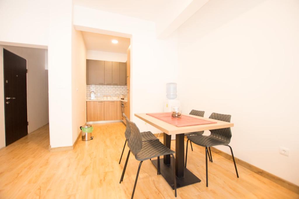 a dining room table and chairs in a room at Trsteno Beach Apartments in Budva