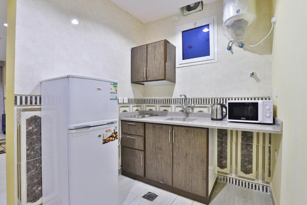 Kuchyň nebo kuchyňský kout v ubytování Shahad Alola Serviced apartments
