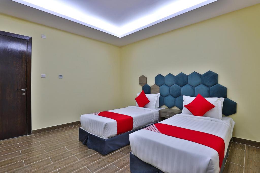Postel nebo postele na pokoji v ubytování Shahad Alola Serviced apartments
