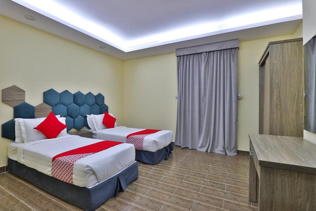 Postel nebo postele na pokoji v ubytování Shahad Alola Serviced apartments