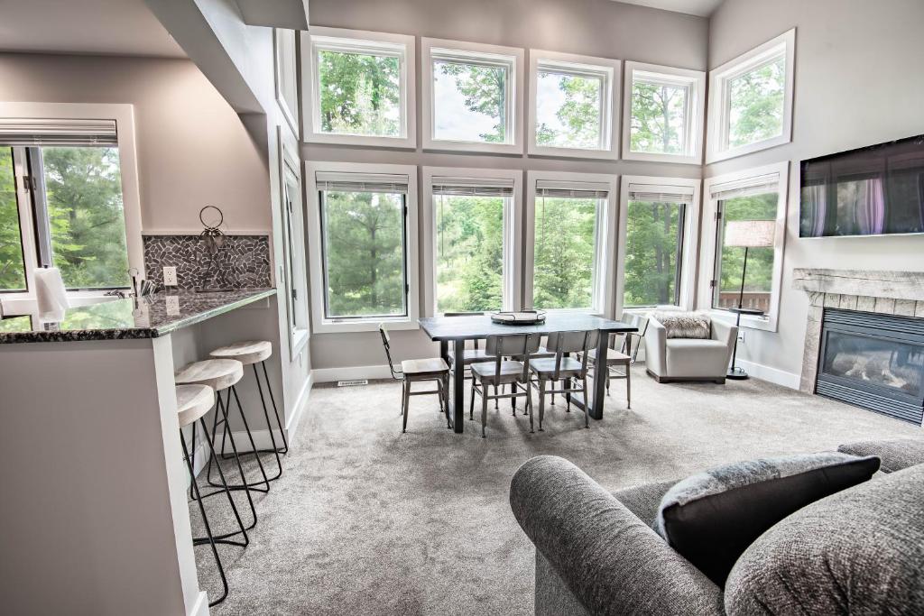 a kitchen and living room with a table and chairs at 620 Disciples Village in Boyne Falls