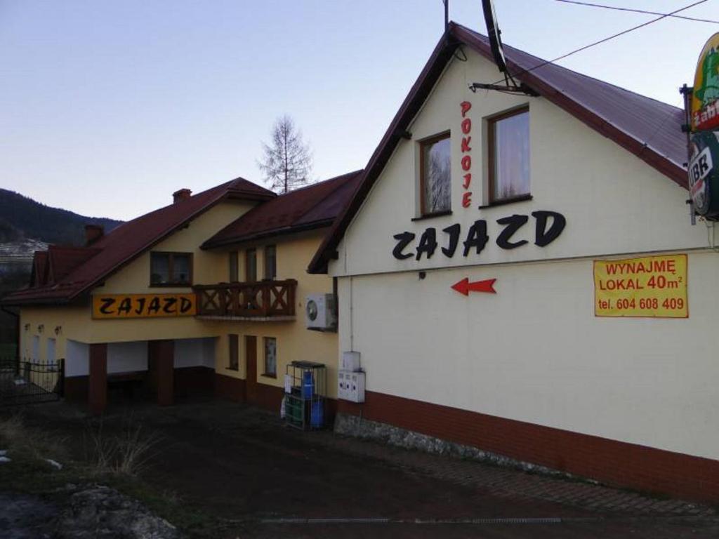 a building with a sign on the side of it at Zajazd Joniec Małgorzata in Dobra