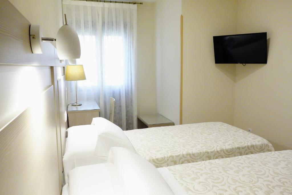 Postel nebo postele na pokoji v ubytování Hostal Toledo
