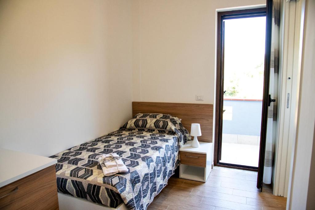 Posteľ alebo postele v izbe v ubytovaní b&b binario nove e tre quarti
