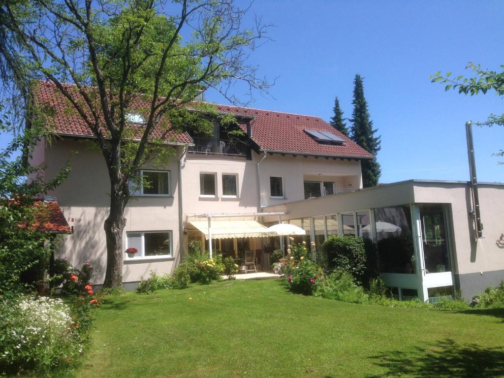 ein großes weißes Haus mit Rasen davor in der Unterkunft Gunkel Ferienwohnungen am See - Konstanz - Musikerviertel in Konstanz