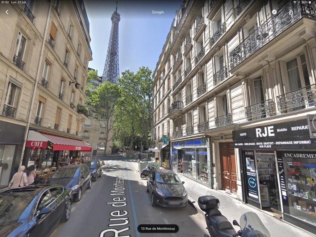 a view of a city street with cars parked on the road at Studio Tour Eiffel in Paris