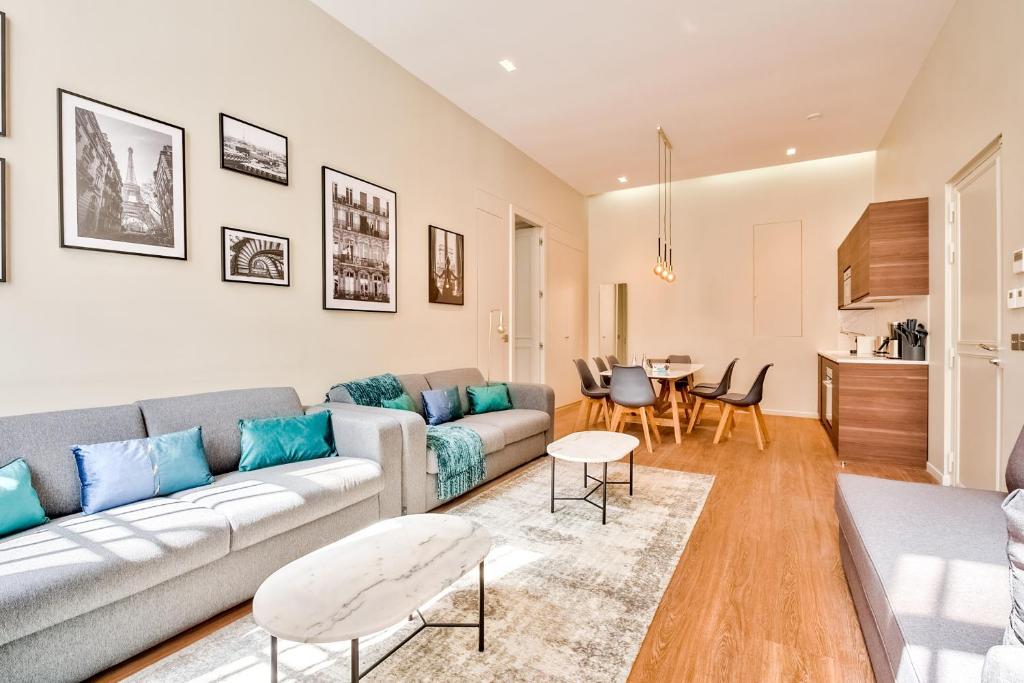 un salon avec un canapé et une table dans l'établissement 91 - Urban Picasso Le Marais, à Paris