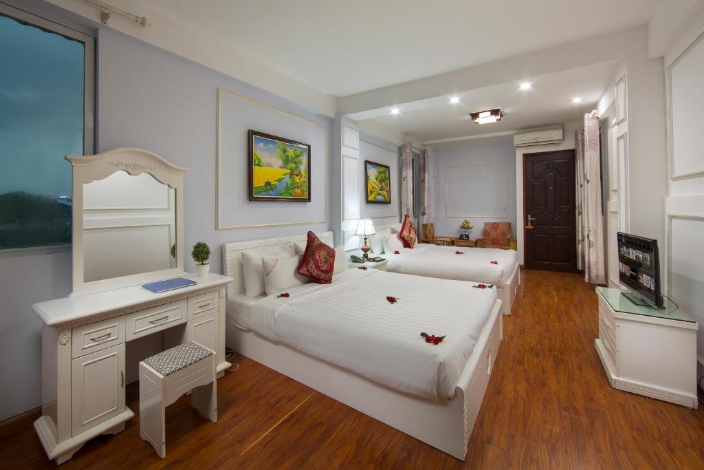 Postel nebo postele na pokoji v ubytování Hanoi City Gate Hotel