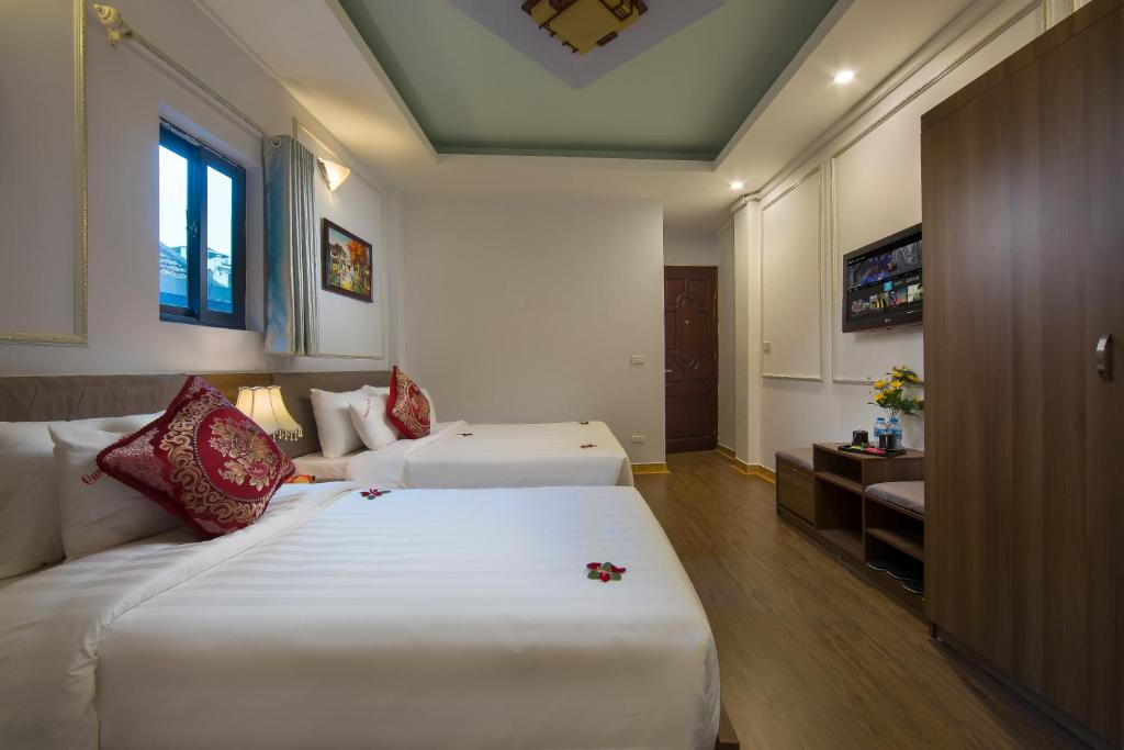 Postel nebo postele na pokoji v ubytování Hanoi City Gate Hotel