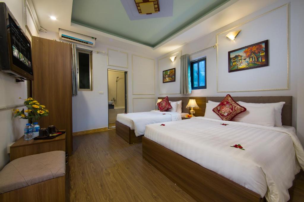Postel nebo postele na pokoji v ubytování Hanoi City Gate Hotel