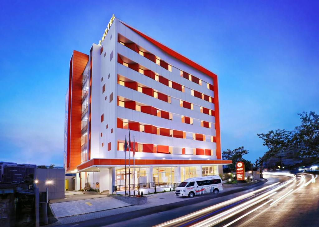 a building with a white van parked in front of it at Starlet Hotel Jakarta Airport in Tangerang