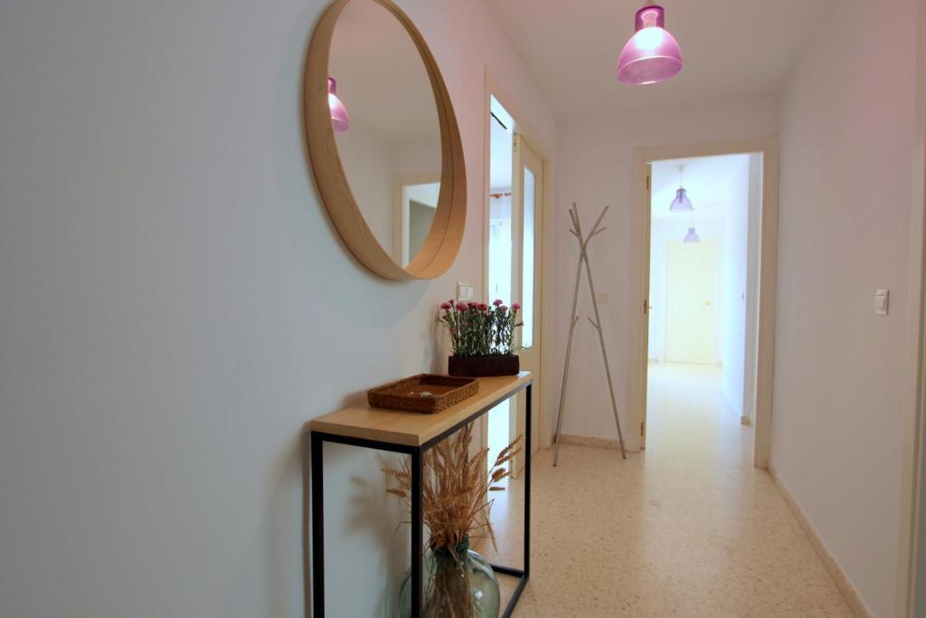 pasillo con espejo y mesa con espejo en Sanlúcar Apart Airen!!, en Sanlúcar de Barrameda