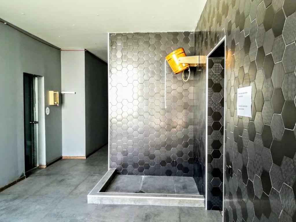 a bathroom with a shower with gray tiles at Apartment N503 Gudauri Loft in Gudauri