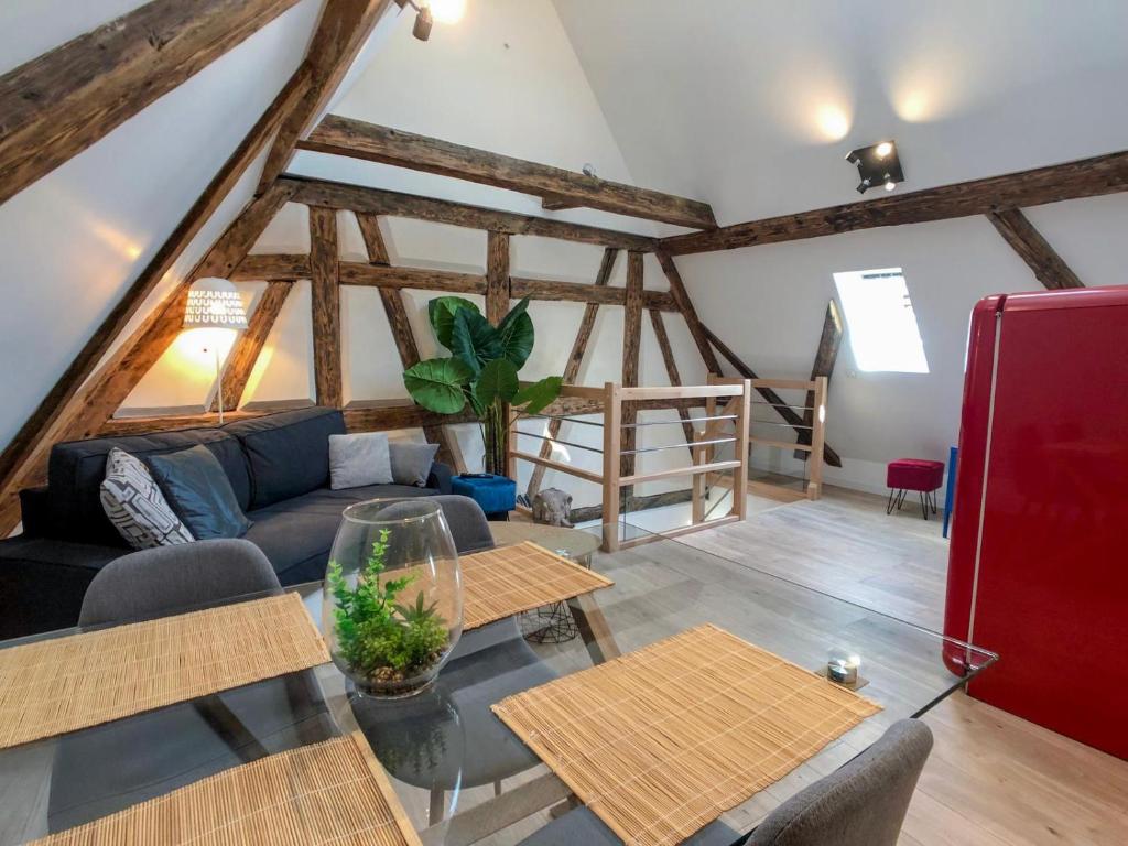 a living room with a couch and a red refrigerator at Beauty & The Beast - Old Town Cosy Apartments in Colmar