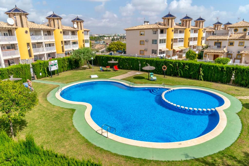 an image of a swimming pool at a resort at Best House Rubi in Playas de Orihuela