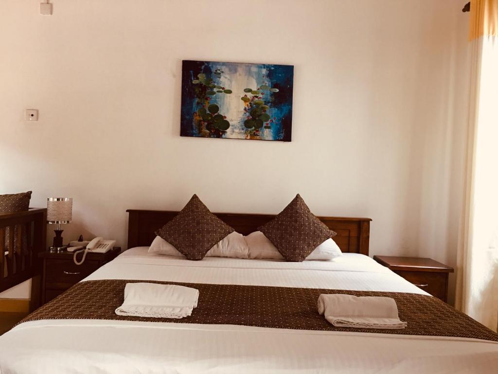 Postel nebo postele na pokoji v ubytování Sarvodaya Samma Vaasa Residence