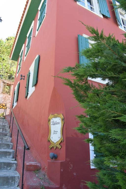 a red building with a sign on the side of it at il Palazzo Rooms & Suites in Nafplio