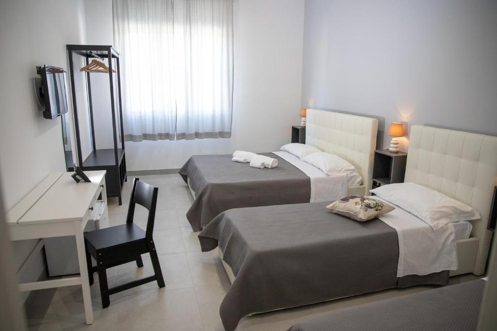 Postel nebo postele na pokoji v ubytování b&b Zio Luciano