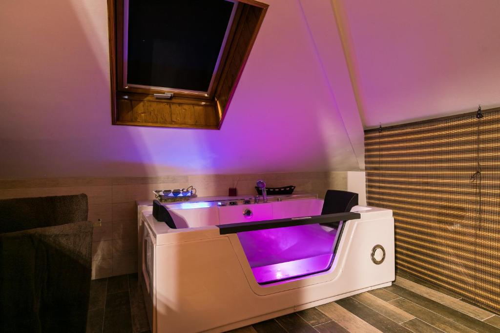 a bathroom with a sink with purple lighting at APARTAMENTOS TURISTICOS TURISToledo in Toledo