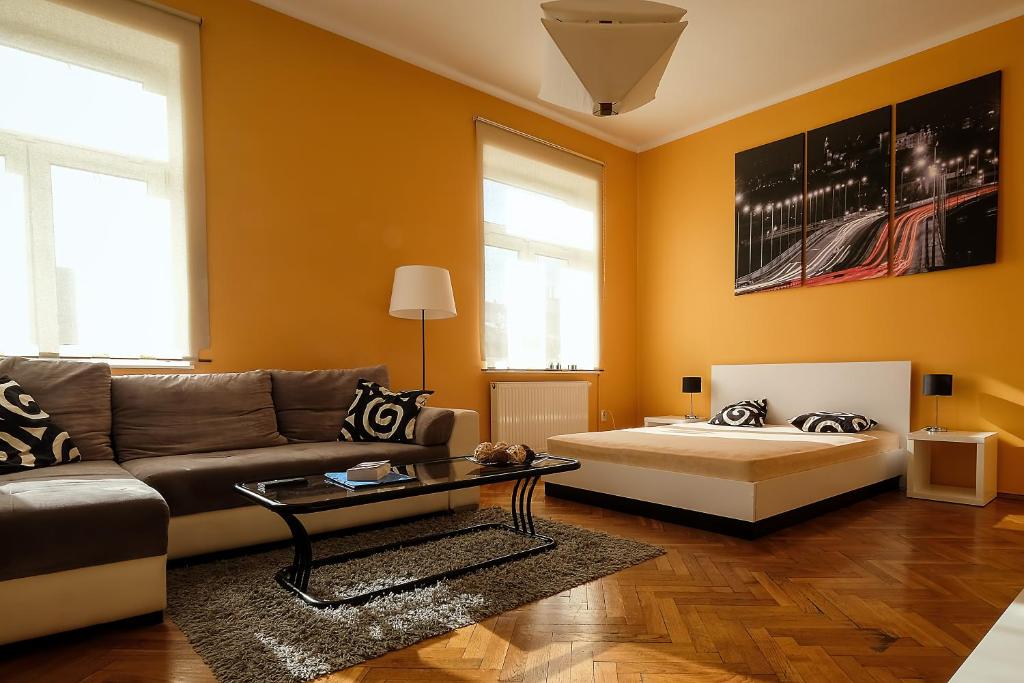 a living room with a couch and a bed at Spacious apartment in the heart of Krakow in Krakow
