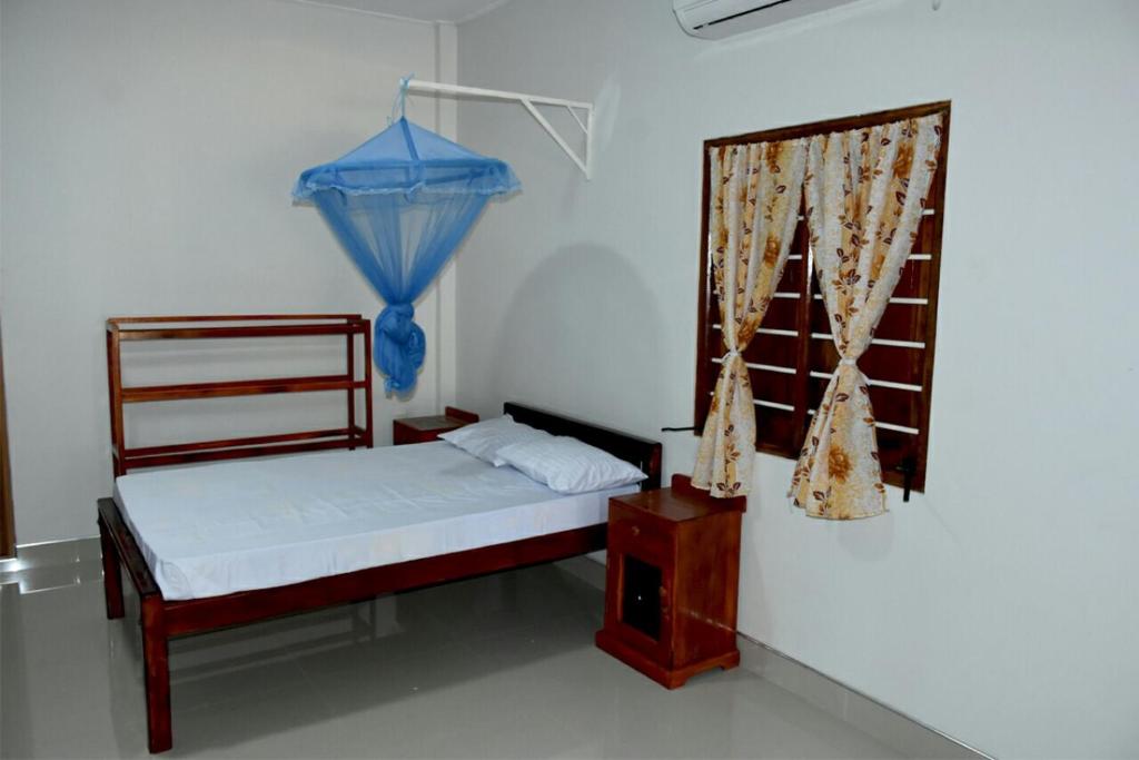 Postel nebo postele na pokoji v ubytování New Land Guest House
