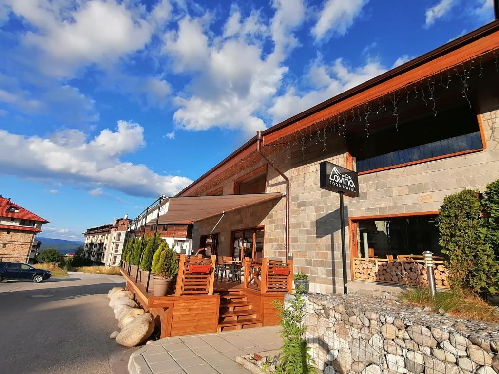 a store with a sign on the side of a building at White Lavina - Ski, Bike, Hike in Bansko