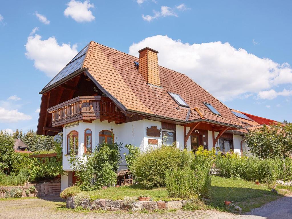 a house with a tiled roof and a porch at Ferienwohnung Haus Barbara in Bräunlingen