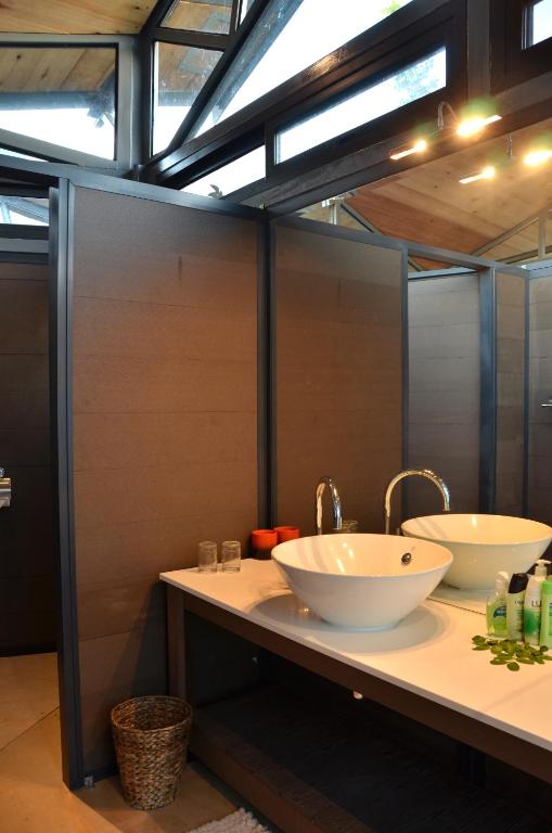 a bathroom with two sinks on a counter at Greenfire Game Lodge in Balule Game Reserve